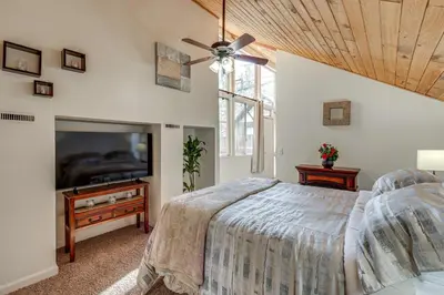 a bedroom with a bed and a flat screen tv at 5 Mi to Mountain High Resort Home with Gaming Area in Wrightwood