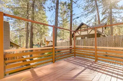 a large wooden deck with a wooden fence and a wooden at 5 Mi to Mountain High Resort Home with Gaming Area in Wrightwood