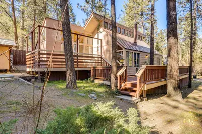 a large house with wooden decks in the woods at 5 Mi to Mountain High Resort Home with Gaming Area in Wrightwood