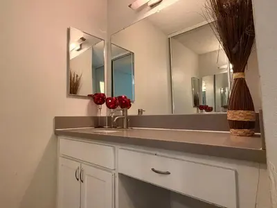 a bathroom with a sink and a mirror at Serene Stay with Pool Access & Balcony in Los Angeles