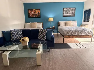 a living room with a couch and a bed at Serene Stay with Pool Access & Balcony in Los Angeles