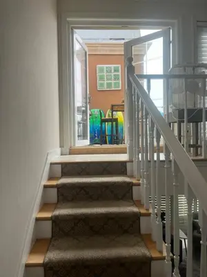 a staircase in a house with a window at Beach Sweet condo home in Los Angeles