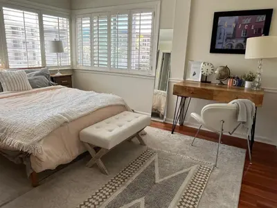 a bedroom with a bed and a desk and a chair at Beach Sweet condo home in Los Angeles