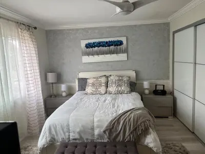 a bedroom with a bed and a ceiling fan at Beach Sweet condo home in Los Angeles