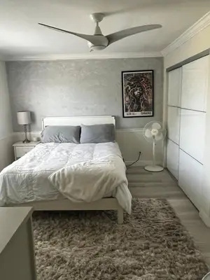 a bedroom with a bed and a ceiling fan at Beach Sweet condo home in Los Angeles