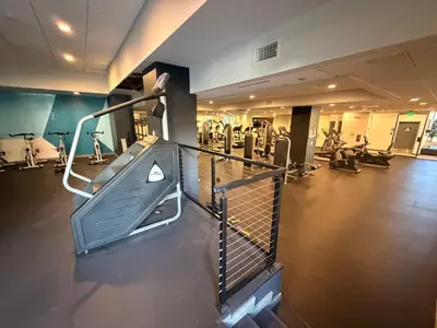 an empty gym with a treadmill and exercise equipment at Hollywood Studio with Pool, Parking, Gym & Sign View in Los Angeles