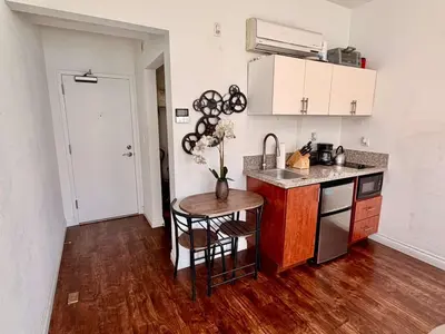 a kitchen with a sink and a table in a room at Modern & Popular Hollywood Studio at GW in Los Angeles