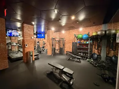 a gym with several exercise equipment in a brick wall at Modern & Popular Hollywood Studio at GW in Los Angeles