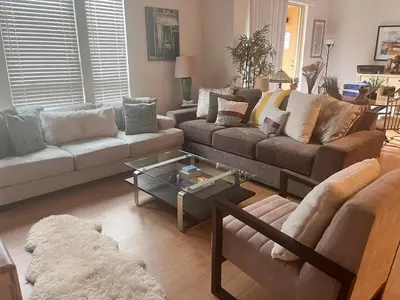 a living room with two couches and a glass table at Sweet Beautiful 2 bedrooms home in Los Angeles