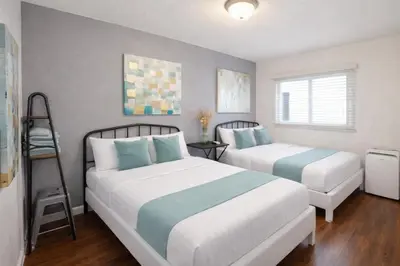 a bedroom with two beds and a ladder at Charming Studio in the Heart of Hollywood in Los Angeles