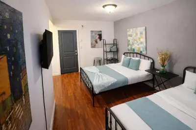 a hotel room with two beds and a television at Charming Studio in the Heart of Hollywood in Los Angeles