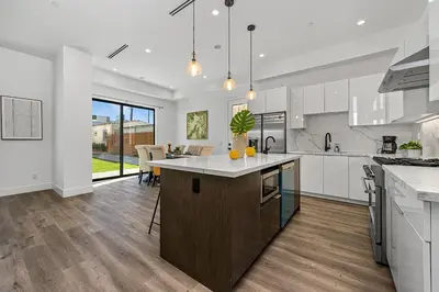 a kitchen with a island in the middle of a room at 5BR Gorgeous Melrose Villa with Parking in Los Angeles