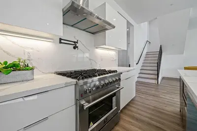 a kitchen with white counters and a stove top oven at 5BR Gorgeous Melrose Villa with Parking in Los Angeles