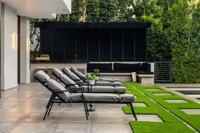 a group of chairs sitting on a patio at Ultra Luxury 5BR Beverly Hills Estate with Private Pool Spa and Canyon Views in Los Angeles