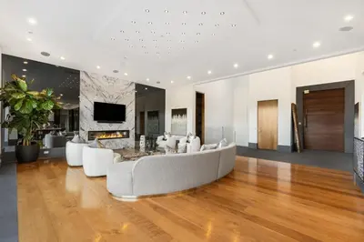 a living room with a couch and a tv at Ultra Luxury 5BR Beverly Hills Estate with Private Pool Spa and Canyon Views in Los Angeles
