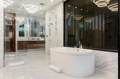 a white bathroom with a tub and a shower at Ultra Luxury 5BR Beverly Hills Estate with Private Pool Spa and Canyon Views in Los Angeles