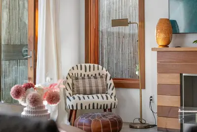a living room with a chair and a table at Vibrant SoCal Venice Beach Retreat in Los Angeles
