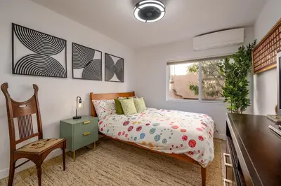 a bedroom with a bed and a desk and a chair at Phenomenal King, Air, Rooftop Deck, Walk to Beach in Hermosa Beach