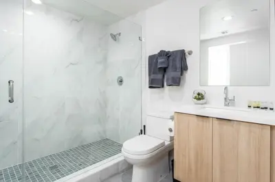 a bathroom with a toilet and a shower and a sink at Modern 3BR Retreat with Rooftop Deck Sleeps 8 in Los Angeles
