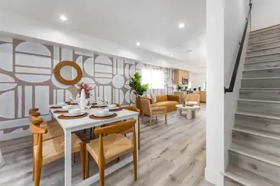 a dining room with a white table and chairs at Modern 3BR Retreat with Rooftop Deck Sleeps 8 in Los Angeles