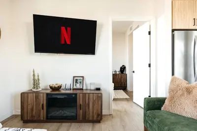 a living room with a tv on a wall at Hollywood Celebrity 2 Bd with SkyLine and Hollywood Sing View in Los Angeles