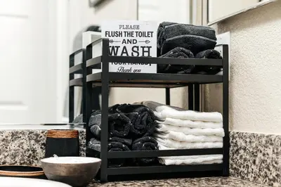 a towel rack with towels and a sign in a store at Stylish Glendale Retreat by Americana & Galleria in Glendale