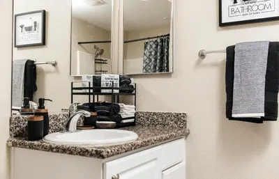 a bathroom with a sink and a mirror at Stylish Glendale Retreat by Americana & Galleria in Glendale