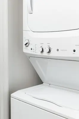 a white washing machine sitting next to a wall at Penthouse Muse, West Hollywood, Los Angeles in Los Angeles