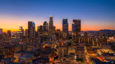 a city skyline at sunset with tall buildings at Sunny LA Bunk Bed in Los Angeles