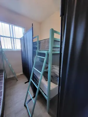 a room with two bunk beds and a refrigerator at Sunny LA Bunk Bed in Los Angeles