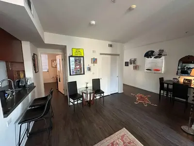 a kitchen and dining room with a table and chairs at Walk to Beach & Promenade Cozy Santa Monica Condo in Los Angeles