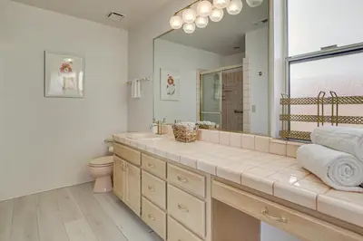 a bathroom with a sink and a toilet and a mirror at Golf, Fish and More! Peaceful Home in Helendale in Helendale
