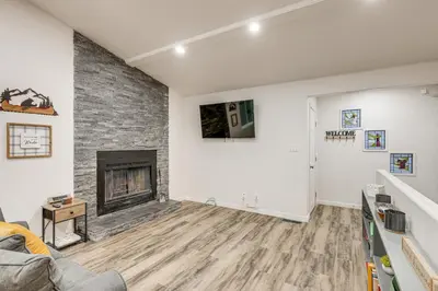 an empty living room with a fireplace at 1 Mi to Lake Gregory! Updated Family Home with Deck in Crestline