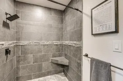 a bathroom with a walk in shower with a sink at 1 Mi to Lake Gregory! Updated Family Home with Deck in Crestline