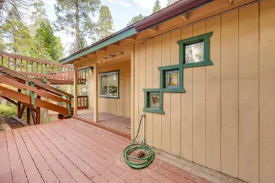 a house with a hose on a wooden deck at 1 Mi to Lake Gregory! Updated Family Home with Deck in Crestline