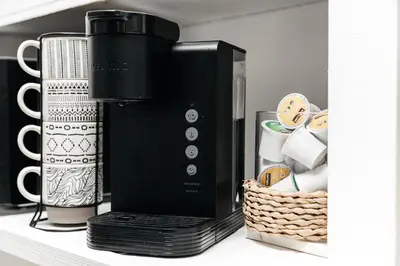 a black coffee maker and a basket on a shelf at Peaceful 2BD Home in WeHo in Los Angeles