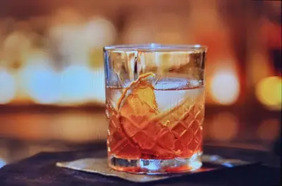 a glass filled with a drink on a table at The Crescent Hotel Beverly Hills in Los Angeles