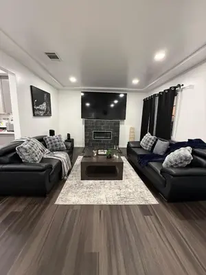 a living room with two couches and a fireplace at Modern2BR Home SoFi LAX Parking Fast WiFi in Los Angeles