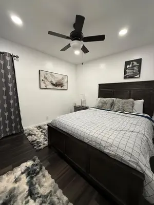 a bedroom with a bed and a ceiling fan at Modern2BR Home SoFi LAX Parking Fast WiFi in Los Angeles