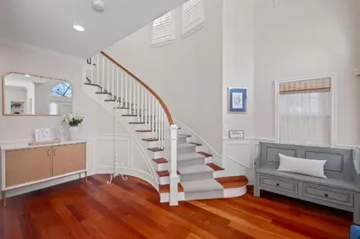 a staircase in a living room with a sink and a mirror at 4br Beach House Steps from Beach with AC Parking BBQ in Hermosa Beach