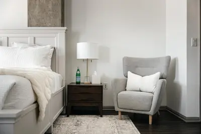 a bedroom with a bed and a chair and a lamp at City Sanctuary - Urban Hideaway in Los Angeles