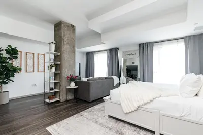 a bedroom with a white bed and a couch at City Sanctuary - Urban Hideaway in Los Angeles