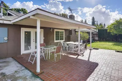 a house with a patio with a table and chairs at 5 Mi to Anaheim Convention Center Retreat with Yard in Anaheim