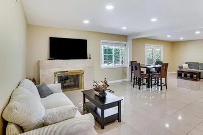 a living room with a couch and a fireplace at 5 Mi to Anaheim Convention Center Retreat with Yard in Anaheim