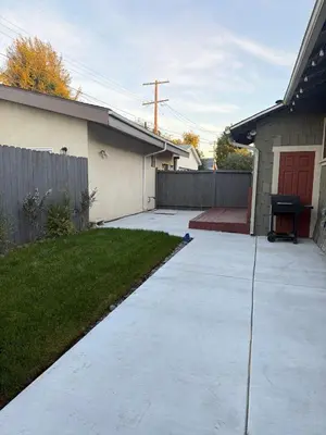 a driveway in front of a house with a fence at Family gateway in the heart of Los Angeles 2bedroom 2bath backyard in Los Angeles