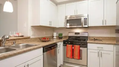 a kitchen with stainless steel appliances and white cabinets at Marina Del Rey Heavenly Stay in Los Angeles