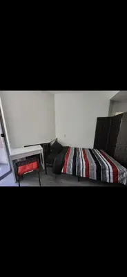 a room with a bed and two chairs in a room at Shared but isolated room in a shared soace in Los Angeles