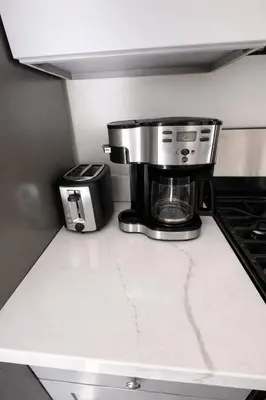 a coffee maker sitting on a counter in a kitchen at Brand new private Home with Yard free parking, near Ontario airport in Ontario
