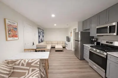a kitchen with a table and a living room at Brand new private Home with Yard free parking, near Ontario airport in Ontario