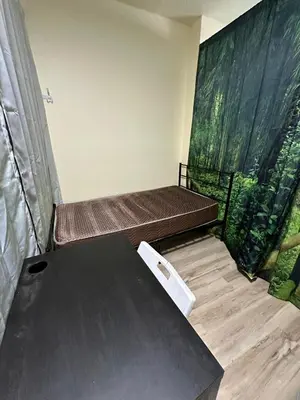 a room with two beds and a table at Shared but isolated room in Central Los Angeles in Los Angeles